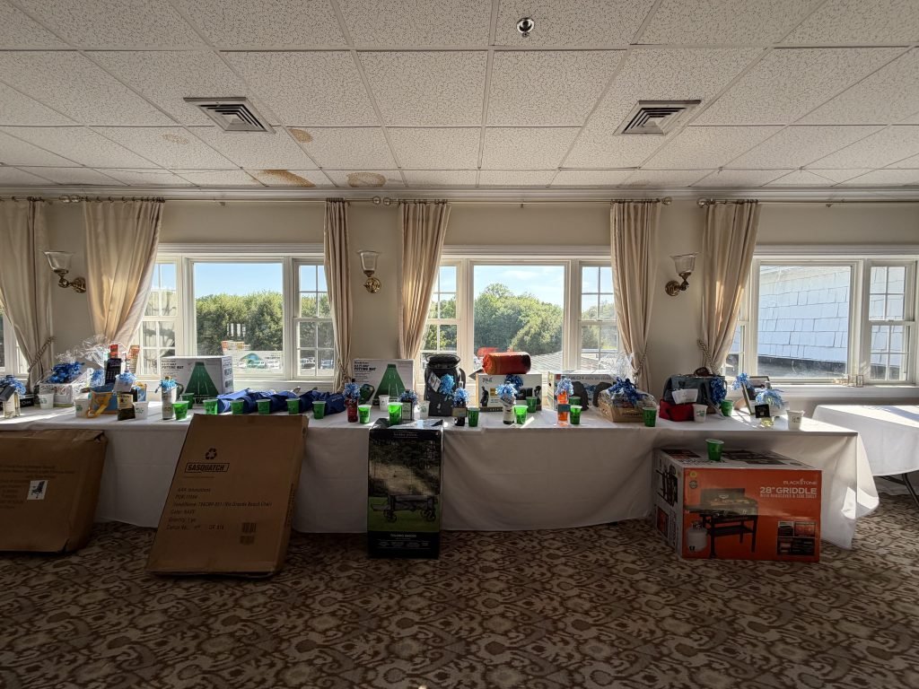 Raffle prizes and tournament items arranged on tables inside the clubhouse.