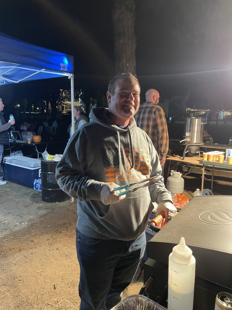 A Movie Night volunteer helps at the hot food station.