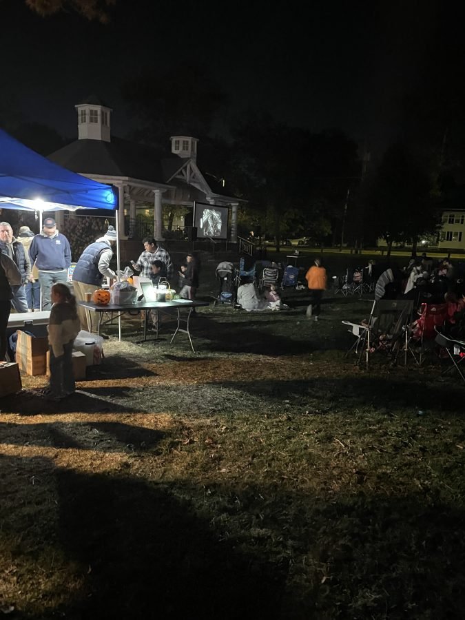 Families gather at Paradise Green for Wilcoxson Fathers Club Movie Night with concessions and Frankenweenie on the outdoor screen.